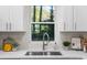 Kitchen sink with a view through a window overlooking mature trees at 1270 Graymont Sw Dr, Atlanta, GA 30310