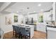 Bright eat-in kitchen features an island with seating, modern stainless appliances, and white cabinetry at 1270 Graymont Sw Dr, Atlanta, GA 30310