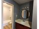 Newly remodeled bathroom with light gray tile in shower over tub, modern vanity and round mirror at 1625 Conley Rd # 171, Conley, GA 30288