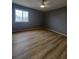 Bedroom featuring new wood floors, neutral paint, and a large window at 1625 Conley Rd # 171, Conley, GA 30288