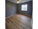 Bedroom with wood floor, neutral walls, and a bright window at 1625 Conley Rd # 171, Conley, GA 30288