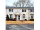 A charming townhome featuring symmetrical design elements, bay windows, and a well-kept yard at 1625 Conley Rd # 171, Conley, GA 30288