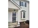 Townhouse front door with security gate, bay window, white columns, and siding at 1625 Conley Rd # 171, Conley, GA 30288