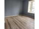 Spacious living room featuring new wood floors and a large window for natural light at 1625 Conley Rd # 171, Conley, GA 30288