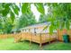 Backyard of home featuring wooden deck and large grassy area at 1975 Glenmar Dr, Decatur, GA 30032