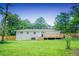 A large backyard with a wooden fence, deck, and stairs at 1975 Glenmar Dr, Decatur, GA 30032