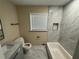 Well-lit bathroom with a marble top vanity, new toilet, soaking tub, and modern fixtures at 1975 Glenmar Dr, Decatur, GA 30032