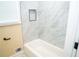 Refinished bathroom featuring a white soaking tub, updated tile, and recessed niche at 1975 Glenmar Dr, Decatur, GA 30032