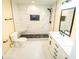 Bathroom featuring a tiled shower, a white vanity, and black hardware at 1975 Glenmar Dr, Decatur, GA 30032