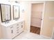 Renovated bathroom with double vanity, modern fixtures, and wood-look flooring in the walk-in closet at 1975 Glenmar Dr, Decatur, GA 30032