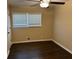 Bedroom featuring dark hardwood flooring, a ceiling fan, and bright, sunny window at 1975 Glenmar Dr, Decatur, GA 30032