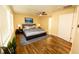 Bright bedroom featuring hardwood floors, a ceiling fan, and a comfortable king-sized bed at 1975 Glenmar Dr, Decatur, GA 30032