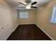 This cozy bedroom features warm paint, a ceiling fan, and a closet for storage at 1975 Glenmar Dr, Decatur, GA 30032