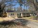 A charming single-story home featuring a well-kept lawn and lush landscaping, with a paved driveway at 1975 Glenmar Dr, Decatur, GA 30032