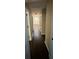 Long hallway featuring hardwood floors, neutral paint, and several doors leading to different rooms at 1975 Glenmar Dr, Decatur, GA 30032