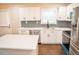 Modern kitchen with stainless steel appliances, quartz countertops, and gray backsplash at 1975 Glenmar Dr, Decatur, GA 30032