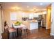 Eat-in kitchen featuring stainless steel appliances, white cabinets, and a kitchen island at 1975 Glenmar Dr, Decatur, GA 30032