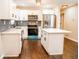 Bright kitchen featuring white cabinets, stainless steel appliances, and a kitchen island at 1975 Glenmar Dr, Decatur, GA 30032