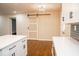 Open kitchen layout with a quartz island, a barn door, and stainless steel appliances at 1975 Glenmar Dr, Decatur, GA 30032