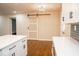 Stylish living room with a barn door, modern lighting, and a view of the kitchen at 1975 Glenmar Dr, Decatur, GA 30032