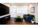 Cozy living room with modern decor, hardwood floors, and natural light from the window at 1975 Glenmar Dr, Decatur, GA 30032