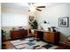 Stylish home office with wooden desk, a modern area rug and plenty of natural light at 1975 Glenmar Dr, Decatur, GA 30032