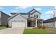 Charming two-story home with a covered front porch, a two-car garage, and a well-manicured lawn at 3071 Birdsong Ave, Covington, GA 30016