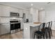Stylish kitchen showcasing stainless steel appliances, a center island with bar seating, and sleek cabinetry at 3071 Birdsong Ave, Covington, GA 30016