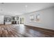 Open-concept living room with hardwood floors, stainless steel appliances, and sliding doors to the backyard at 3071 Birdsong Ave, Covington, GA 30016