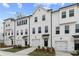 New townhome exteriors with integrated garages, black accents and manicured lawns at 3160 Washburn Sw St, Atlanta, GA 30354
