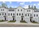Modern townhomes feature white exteriors, individual garages, and neatly landscaped front yards at 3160 Washburn Sw St, Atlanta, GA 30354