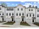 Modern townhomes showcase a uniform design with white exteriors and well-kept landscaping at 3160 Washburn Sw St, Atlanta, GA 30354
