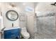 Updated bathroom featuring a vanity with blue cabinets and a stylish tiled shower at 3345 Highgate Hills Ne Dr, Duluth, GA 30097