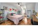 Light-filled bedroom showcases hardwood floors, ceiling fan, and unique decorative touches at 3345 Highgate Hills Ne Dr, Duluth, GA 30097
