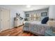 Cozy bedroom with blue walls and patterned bedding with hardwood floors and natural light at 3345 Highgate Hills Ne Dr, Duluth, GA 30097