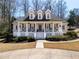 Charming two-story home featuring a covered front porch, dormer windows, and manicured landscaping at 3345 Highgate Hills Ne Dr, Duluth, GA 30097