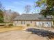 Attached three car garage with a paved driveway on a sunny day at 3345 Highgate Hills Ne Dr, Duluth, GA 30097