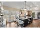 A spacious kitchen features an oversized granite island, hardwood floors, and ample natural light at 3345 Highgate Hills Ne Dr, Duluth, GA 30097