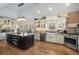 Spacious kitchen featuring a large island, modern appliances, and custom cabinetry at 3345 Highgate Hills Ne Dr, Duluth, GA 30097