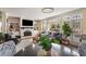 Cozy living room with a fireplace, built-in shelving, and large windows offering natural light at 3345 Highgate Hills Ne Dr, Duluth, GA 30097