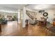 Open-concept living space with hardwood floors, staircase, and seamless flow between living and dining areas at 3345 Highgate Hills Ne Dr, Duluth, GA 30097