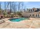 Inviting swimming pool with outdoor fireplace and well-manicured surroundings at 3345 Highgate Hills Ne Dr, Duluth, GA 30097