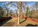 Fenced backyard with mature tree and grass at 884 N Eugenia Nw Pl, Atlanta, GA 30318