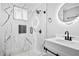 Beautiful bathroom featuring marble style tile, sleek matte black fixtures, and stylish vanity and sink at 884 N Eugenia Nw Pl, Atlanta, GA 30318
