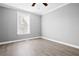 Cozy bedroom with light gray walls, updated flooring and natural light from a large window at 884 N Eugenia Nw Pl, Atlanta, GA 30318