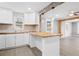 Modern kitchen with butcher block countertops, white cabinetry, and views into the living room at 884 N Eugenia Nw Pl, Atlanta, GA 30318