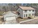 Exterior of the home with a 2-car garage and a well-manicured lawn at 1791 Lake George Dr, Lithia Springs, GA 30122