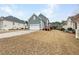 Backyard view showcasing the home's garage, yard, and back deck at 185 Stayman Park, Fayetteville, GA 30215