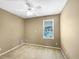 Neutral bedroom featuring carpet, a ceiling fan, and a window that offers outside views at 185 Stayman Park, Fayetteville, GA 30215