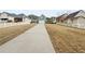Long driveway leading to a home with a white picket fence, surrounded by well-maintained lawns at 185 Stayman Park, Fayetteville, GA 30215